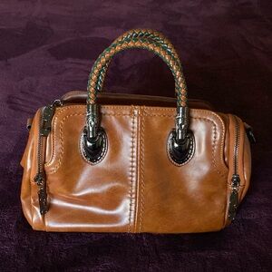 Xidabaolou satchel handbag. Faux leather but is very substantial and heavy.